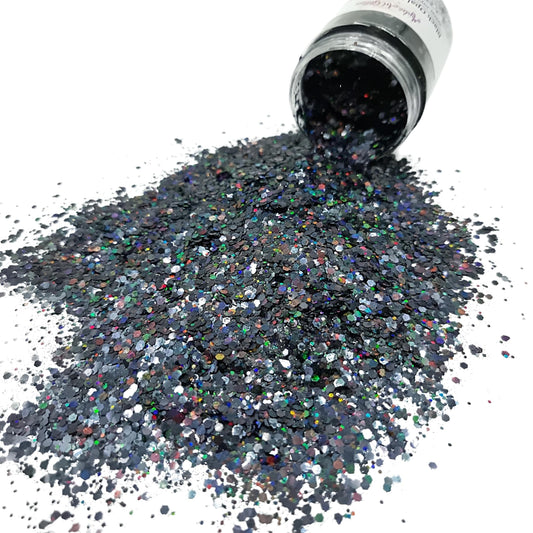 Black Opal Mix holographic glitter. It shows hints of colours that reflect the rainbow, a spectrum of color